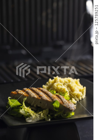 tuna fish steak with couscous and salad tuna fish steak with couscous and salad 125789251