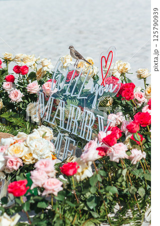 Beach Proposal Decor with Will You Marry Me Sign, Flowers and Cozy Area. Will You Marry Me Proposal 125790939