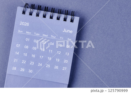 June 2026 Monthly desk calendar for 2026 year on blue background. June 2026 Monthly desk calendar for 2026 year on blue background. 125790999