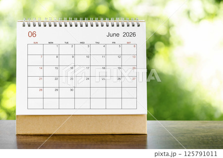 June 2026 Calendar desk for organizer to plan and reminder on wooden table. June 2026 Calendar desk for organizer to plan and reminder on wooden table. 125791011