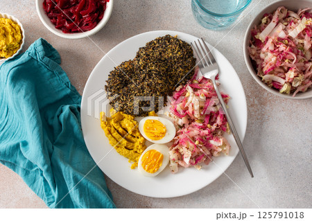 A vibrant, healthy breakfast with quinoa pancakes, crisp cabbage, radish, and mung bean sprouts, complemented by boiled eggs, hummus, and beets for a nutrient-packed meal A vibrant, healthy breakfast with quinoa pancakes, crisp cabbage, radish, and mung bean sprouts, complemented by boiled eggs, hummus, and beets for a nutrient-packed meal 125791018