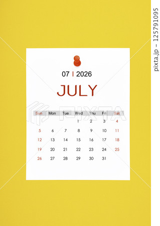July 2026 calendar page with push pin on yellow background. July 2026 calendar page with push pin on yellow background. 125791095
