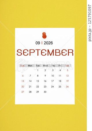 September 2026 calendar page with push pin on yellow background. 125791097