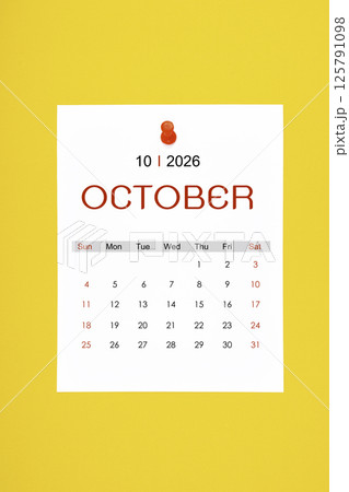 October 2026 calendar page with push pin on yellow background. October 2026 calendar page with push pin on yellow background. 125791098
