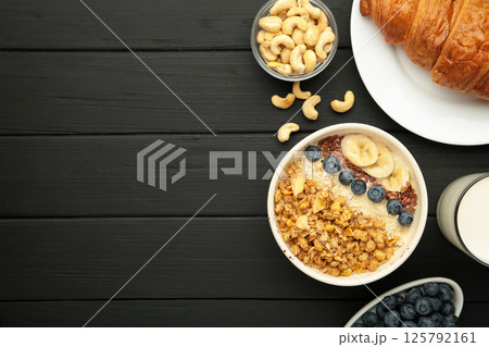 Healthy breakfast set on black background. Granola with fresh summer berries. Space for text Healthy breakfast set on black background. Granola with fresh summer berries. Space for text 125792161