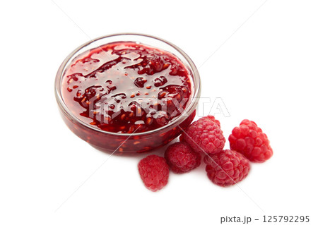 Raspberry jam jelly in bowl with berries isolated on white background. Raspberry jam jelly in bowl with berries isolated on white background. 125792295