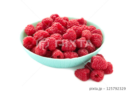 Raspberries in mint bowl isolated on white background Raspberries in mint bowl isolated on white background 125792329