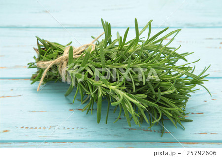 Fresh rosemary bunch on blue wooden background 125792606
