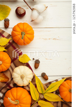 Autumn composition. White and orange pumpkin with autumn leaves on white background. Thanksgiving day 125792868