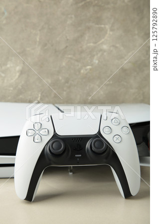 Mykolaiv, UKRAINE - July, 2024: Presentation of a new product from Sony, wireless white console PlayStation 5 and gamepad on light background, game console 125792890