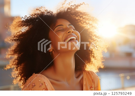 Beautiful woman with long hair enjoying the mesmerizing sunrise in a scenic natural setting Beautiful woman with long hair enjoying the mesmerizing sunrise in a scenic natural setting 125793249
