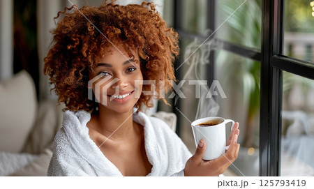 Smiling Young Woman In Bathrobe Enjoying Morning Coffee, Relaxation And Home Comfort Concept. Smiling Young Woman In Bathrobe Enjoying Morning Coffee, Relaxation And Home Comfort Concept. 125793419