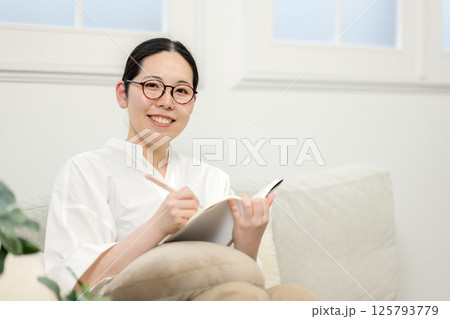 ソファ読書をするウィルビー女性|勉強|趣味|健康的な暮らしイメージ|ウェルビー女子|ウェルビーイング ソファ読書をするウィルビー女性|勉強|趣味|健康的な暮らしイメージ|ウェルビー女子|ウェルビーイング 125793779