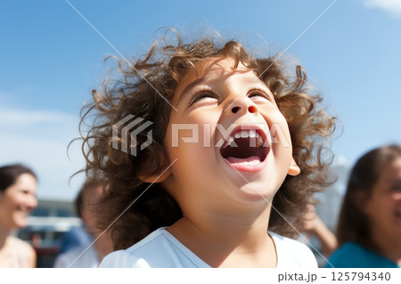 Innocent childs radiant smile in sunbeams, emanating warmth and joyful ambiance 125794340