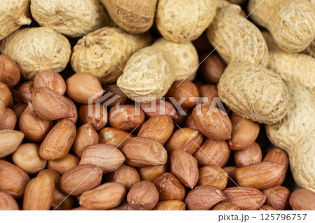 Shelled and Unshelled Peanuts Close-Up Shelled and Unshelled Peanuts Close-Up 125796757