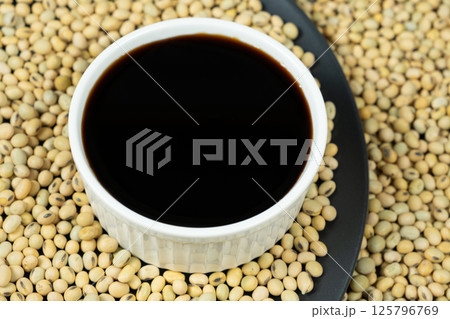 Close-Up of Soy Sauce and Scattered Soybeans Close-Up of Soy Sauce and Scattered Soybeans 125796769