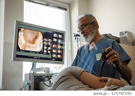 Gastroscopy procedure on sedated patient to examine upper digestive tract. 125797193