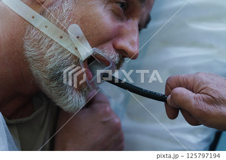Gastroscopy procedure on sedated patient to examine upper digestive tract. 125797194