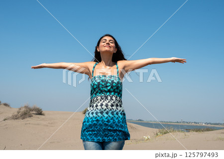 Happy woman portrait with her arms raised up. Happy woman portrait with her arms raised up. 125797493
