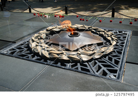 Eternal flame memorial with bronze laurel wreath symbolizing honor, sacrifice and remembrance. Victory Day 125797495