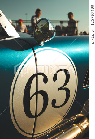 Classic vintage race car number 63 in turquoise and white finish with chrome round mirror 125797499