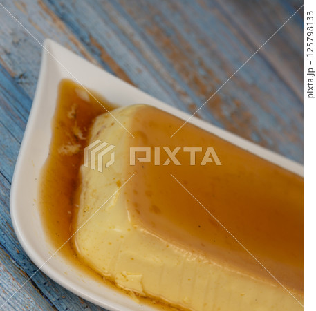 Cream caramel pudding with caramel sauce on a plate, Flan 125798133
