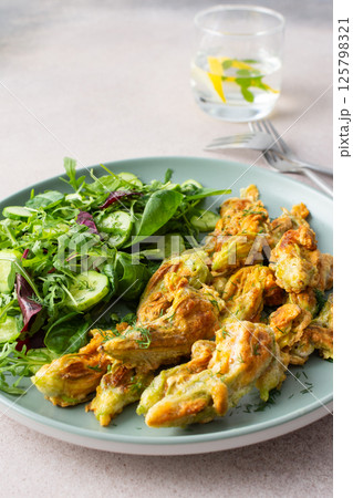 Zucchini flowers in batter and salad Zucchini flowers in batter and salad 125798321