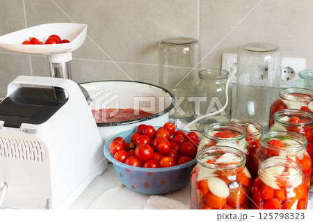 Homemade tomato preserves and tomato juice, canned and sealed for winter storage, maintaining flavor and freshness Homemade tomato preserves and tomato juice, canned and sealed for winter storage, maintaining flavor and freshness 125798323