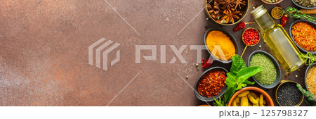 A visually striking arrangement of fresh spices and herbs on a brown surface, highlighting their vivid colors, intricate details, and rich culinary essence, banner A visually striking arrangement of fresh spices and herbs on a brown surface, highlighting their vivid colors, intricate details, and rich culinary essence, banner 125798327