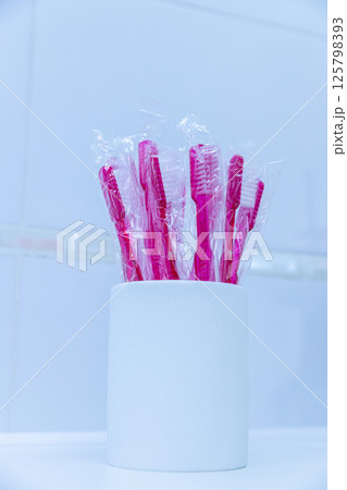 A Collection of Bright Pink Toothbrushes in a White Holder, Perfectly Arranged for Oral Care with a Clean and Modern Aesthetic A Collection of Bright Pink Toothbrushes in a White Holder, Perfectly Arranged for Oral Care with a Clean and Modern Aesthetic 125798393