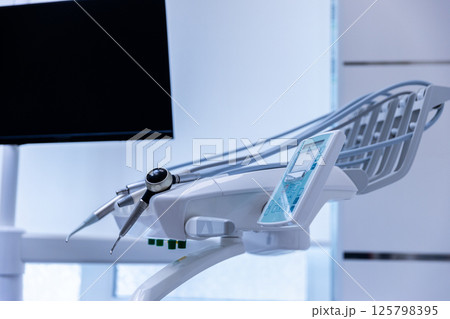 Modern Dental Chair and Equipment: A Glimpse into the State-of-the-Art Dental Clinic Environment Emphasizing Advanced Dental Care and Patient Comfort for Optimal Oral Health Experience. 125798395
