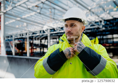 Construction workers at work on modern building site. 125798632