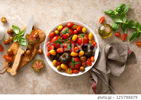 Fresh ripe cherry tomatoes and large red tomatoes, top view Fresh ripe cherry tomatoes and large red tomatoes, top view 125798879