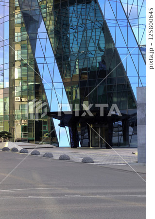 Modern office building made of tempered glass. 125800645
