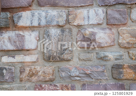 Structural wall of the ancient building of the last century from a stone. Structural wall of the ancient building of the last century from a stone. 125801929