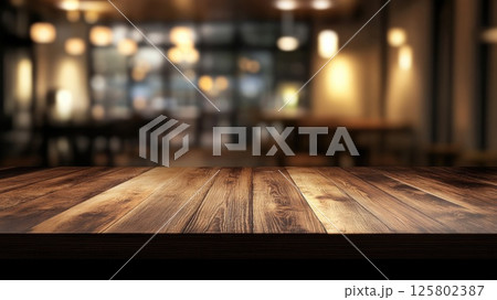 Fashionable wooden table top in a cozy modern cafe with warm lighting and welcoming atmosphere on a blurred background 125802387
