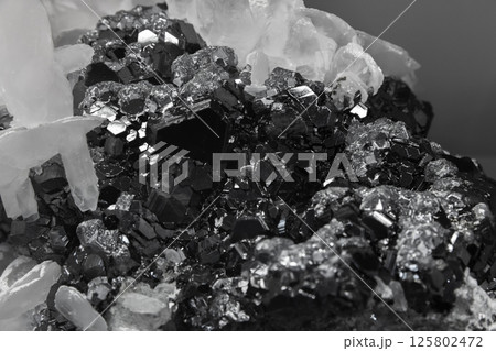 A cluster of flattened calcite crystals. Detailed view of metallic crystals 125802472