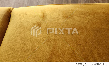 Close up of stained and scratched mustard yellow velvet upholstery of sofa Close up of stained and scratched mustard yellow velvet upholstery of sofa 125802518