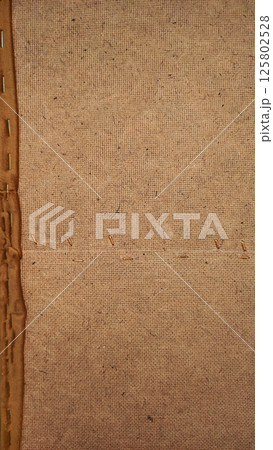 Close up of burlap fabric showing stitching and texture details of sofa 125802528