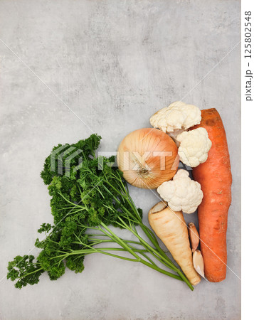 Fresh vegetables lying on gray kitchen countertop ready for cooking copy space preparing vegetables for making soup 125802548