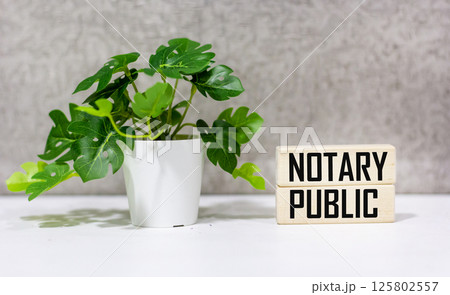 The text "NOTARY PUBLIC" on wooden blocks and a beautiful background 125802557