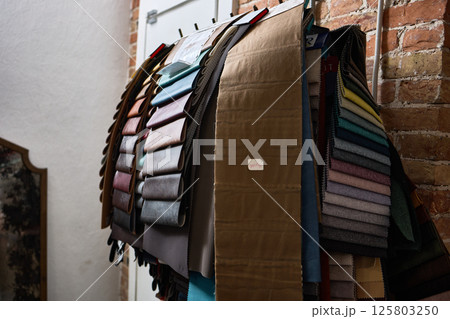 Colorful fabric swatches displayed indoors for textile samples and design selection, interior decor inspiration concept 125803250