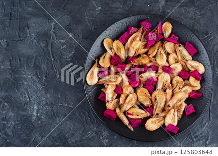 Shrimp cooked in a fruit marinade. 125803648