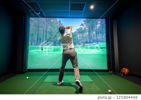 Golfer playing golf in indoor simulator Mixed media. golf simulator 125804448