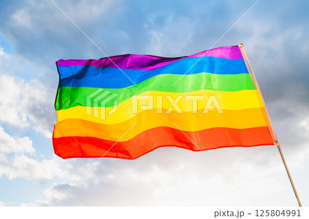 LGBTQ Pride Flag on cloudy sky  125804991