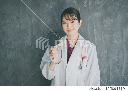 虫眼鏡を持つ女性医師 虫眼鏡を持つ女性医師 125805519