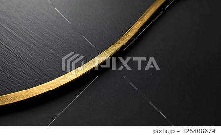 sleek, sophisticated design featuring metallic gold curved detail against matte black surface, creating high end aesthetic that exudes elegance and modernity 125808674