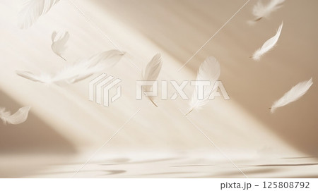 Several delicate white feathers gently falling in soft sunlight against a warm beige background with subtle shadows. Airy and peaceful composition AI generated 125808792