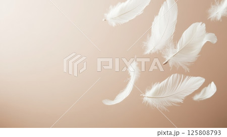 Several soft white feathers gently floating against a smooth, light beige background. Airy and delicate composition with ample copy space AI generated 125808793