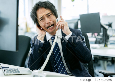 カスタマーハラスメントを受ける男性 125808960